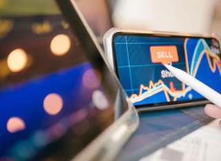 Trader working across multiple markets, examining Bitcoin Ethereum and forex options